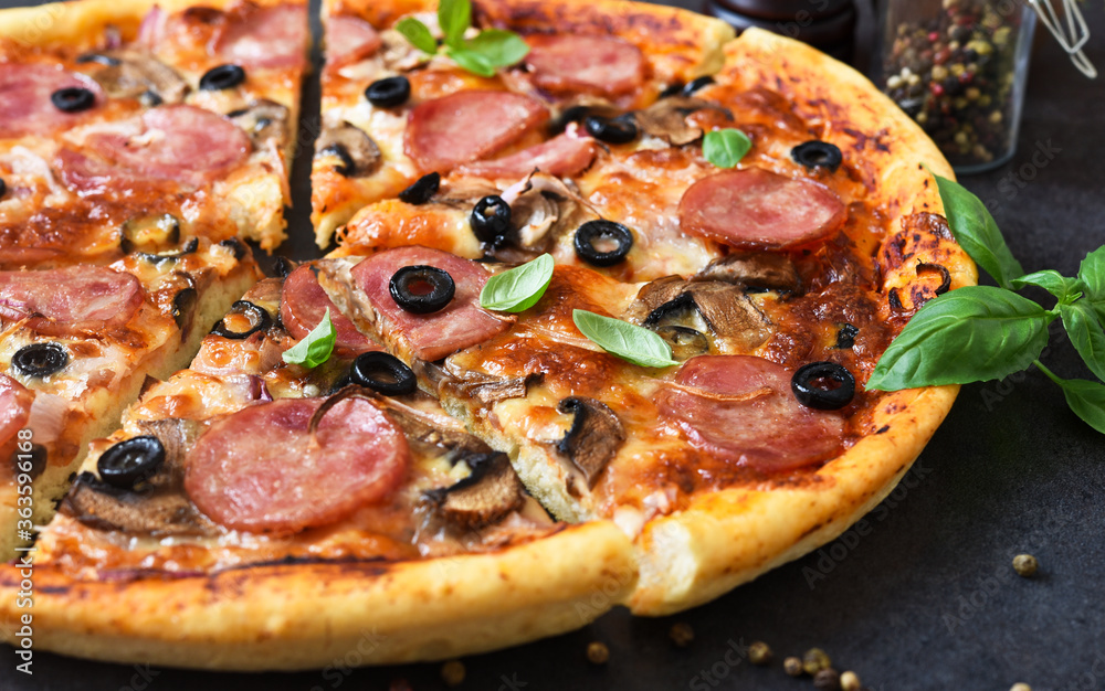 Pizza slices with mushrooms and olives on a black background. Pizza slices with mushrooms and olives on a black background.