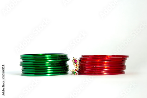 Stacked upon each other green bangles in front of bangales Maharashtrian nose pin ( marathi nath )
 photo