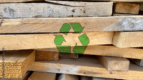 Recycling arrow icon on waste wooden piles from a construction site, reuse and reduce to protect earth environment, abstract responsible and sustainable development concept