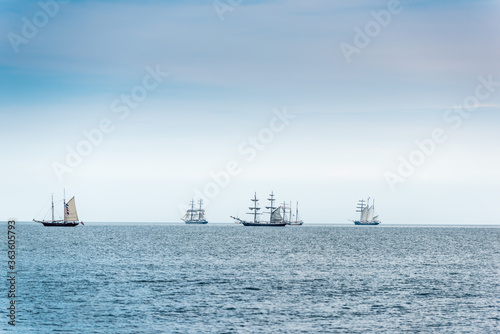 Tall Ships on blue water. Tall ships parade.