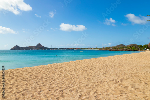 Vacation beach scenery with a headland in the background