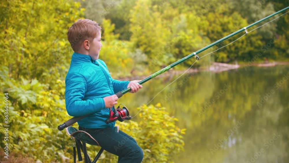 A little boy holding fishing rod and spinning the roulette A little boy holding fishing rod and spinning the roulette