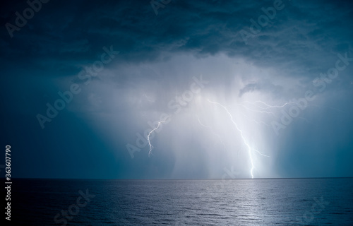 lightning over the sea in the night © Omeliyen