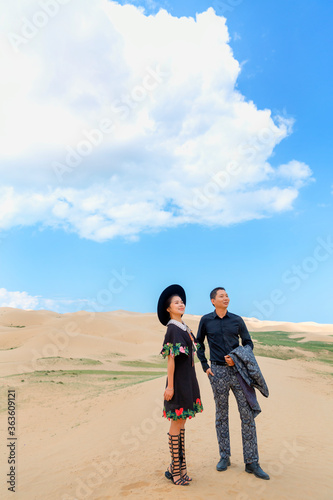 A couple traveling in the desert.