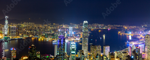 Aerial panoramic view of Hong Kong Island and Kowloon at night, Hong Kong city at night from the Victoria peak, China.