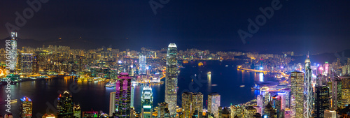Aerial panoramic view of Hong Kong Island and Kowloon at night, Hong Kong city at night from the Victoria peak, China.