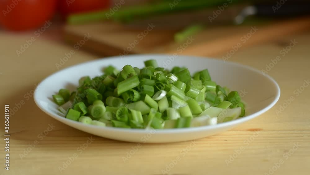 Fresh green onions on the table.Sliced green onions for salad. Healthy food vitamins. Fresh green onions on the table.Sliced green onions for salad. Healthy food vitamins.