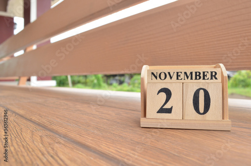 November 20, Number cube with wooden balcony background. photo