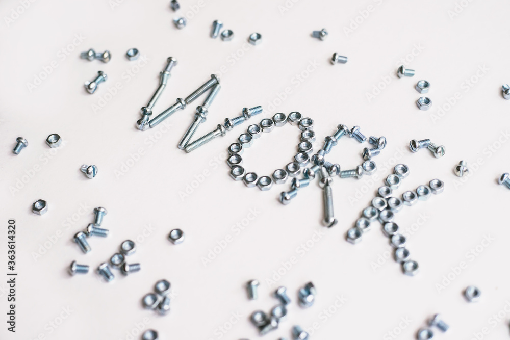 The inscription is the word work lined with bolts and nuts. Bolts and nuts on a white background. The inscription is the word work lined with bolts and nuts. Bolts and nuts on a white background.