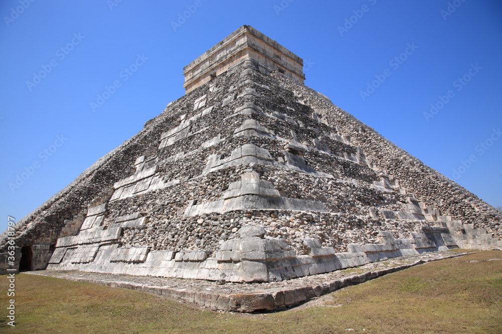 View of Kukulcan temple Pyramid under blue sky in Chichen Itza,  Yucatan, Mexico