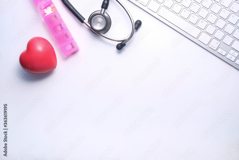 high angle view of pills , keyboard and stethoscope on clinic desk . high angle view of pills , keyboard and stethoscope on clinic desk .
