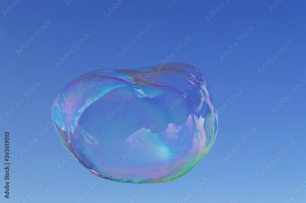 large iridescent soap bubble with oval shape large iridescent soap bubble with oval shape