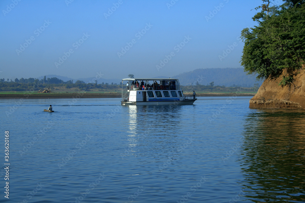 Small cruise boat with beautiful landscape at Narmada River.