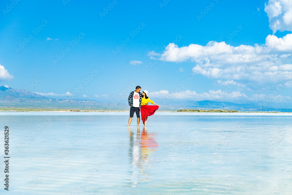 A couple frolicking in a lake in the sea.