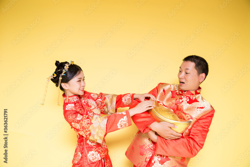 Male and female models in traditional Chinese wedding costumes. Male and female models in traditional Chinese wedding costumes.