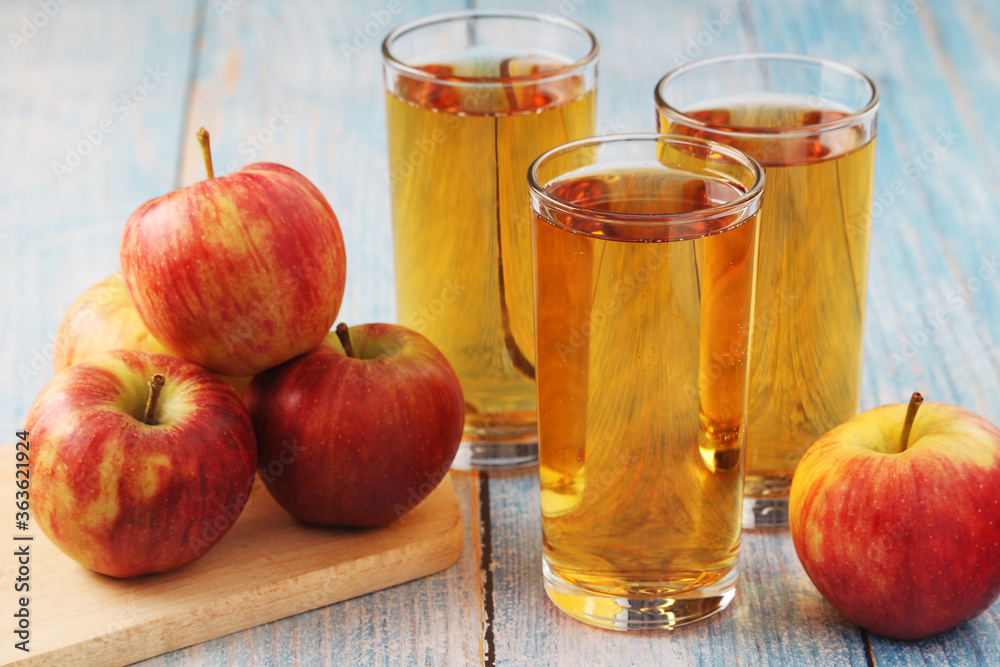 Glasses with apple juice and ripe apples Glasses with apple juice and ripe apples