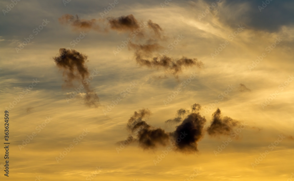 Obraz premium Shroud of clouds. Light and dark clouds in the sunset sky.