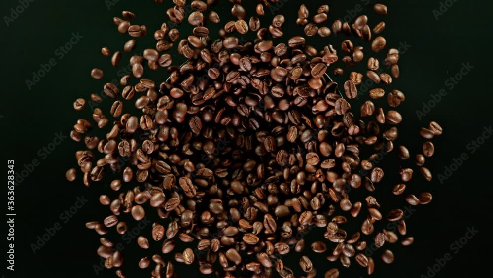 Coffee beans explosion, super slow motion, top view.