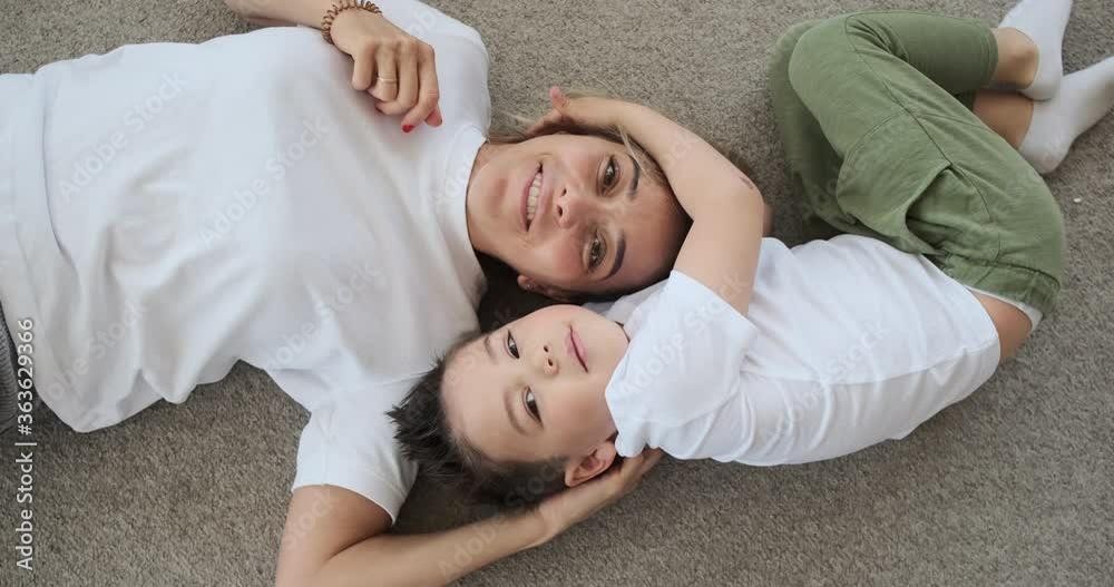 Loving mother and son having fun lying on the floor at home Loving mother and son having fun lying on the floor at home