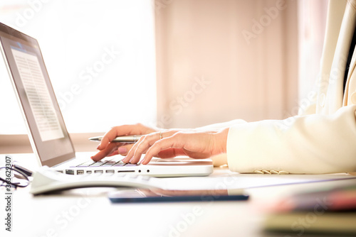 Shot of businesswoman's hand typing on laptop