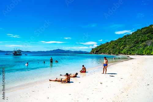 Coron  Philippines - January 3  2020  People relaxing on Malcapuya Island  Coron  Philippines.
