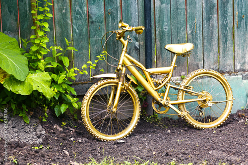 golden bicycle as a formal garden decoration