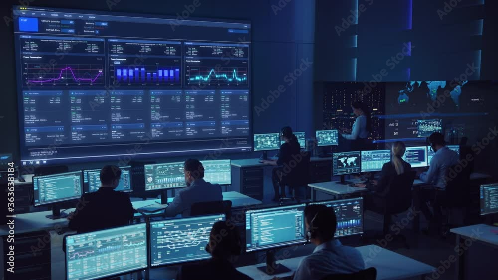 Team of Professional Computer Data Science Engineers Work on Desktops with Screens Showing Charts, Graphs, Infographics, Technical Neural Data and Statistics. Low Key Control and Monitoring Room.