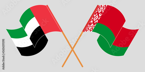 Crossed and waving flags of Belarus and the United Arab Emirates