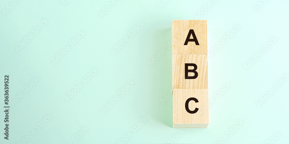 letters abc on wooden cubes and space for text on mint green letters abc on wooden cubes and space for text on mint green