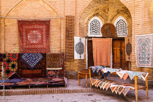 The wide range of the hand made carpets in traditional style in the small bazaar, Khiva, Uzbekistan, Central Asia photo