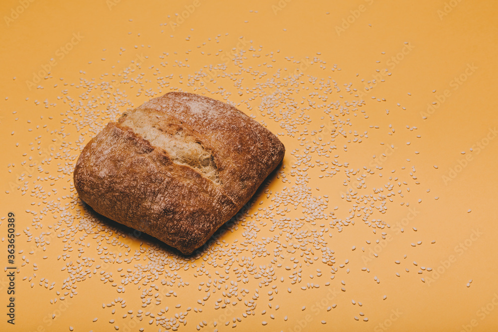 Naklejka premium Cereal bread on yellow bakcground.