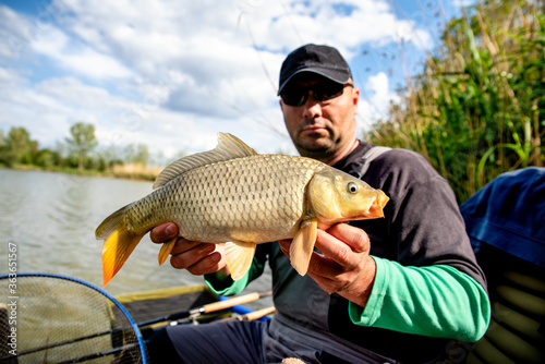Fisherman posing with carp that he had catched
