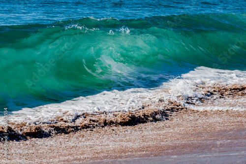 Surf waves crash in on Tairua beach on Coromandel Peninsula, New Zealand photo