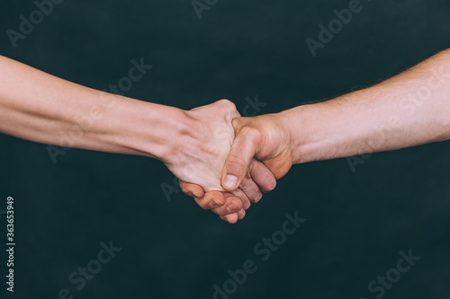 Girl with a guy shake hands with each other.
