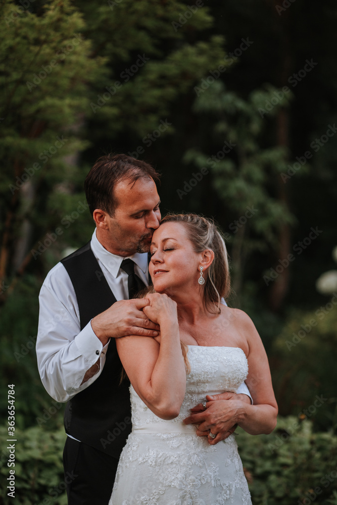 Bride and Groom Sharing Affectionate Embrace Bride and Groom Sharing Affectionate Embrace