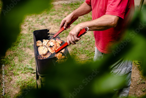 A man preparing barbecue in the garden