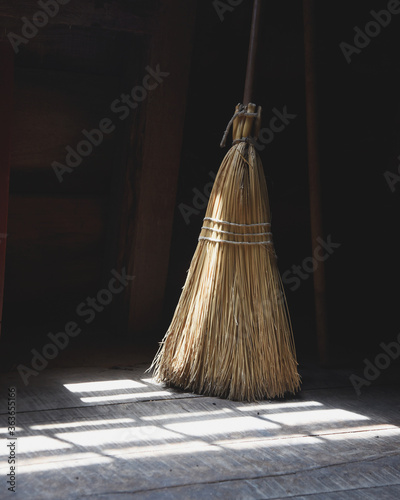 Old Broomstick in Room with Light Shadow