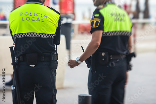 Photography Spanish police squad formation back view with Local Police logo emblem on unif
