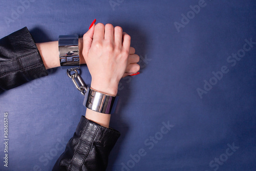 hands in iron handcuffs, the theme of BDSM