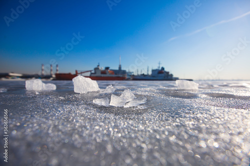 The Icebreaker ship vessel trapped in ice tries to break and leave the bay between the glaciers © tsuguliev