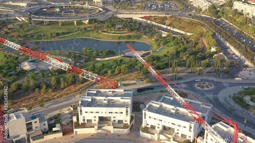 Construction Site and Cranes silhouette, In modiin City,Israel,Aerial view, 
Drone view,July, Sunset,2020
 photo