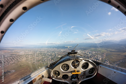 Glider flying over urban area photo