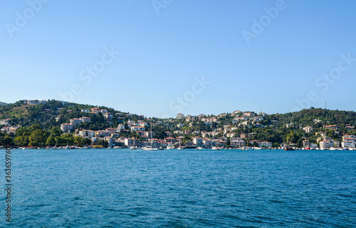 Beautiful view of the residential area, hillside waterfront colorful houses and a park from the Bosphorus Strait in Istanbul, Turkey. © Dmytro