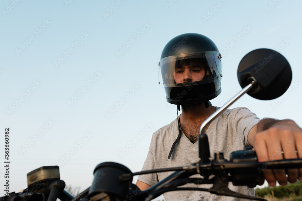 Serious man in helmet riding motorcycle Serious man in helmet riding motorcycle