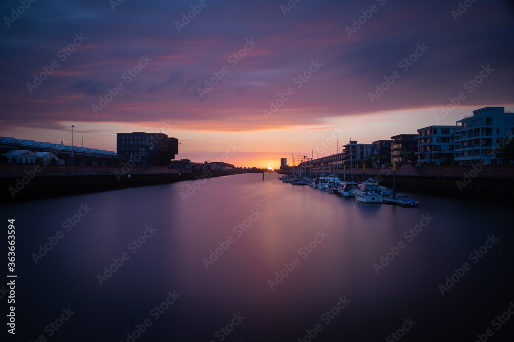 panorama of the river Weser in Bremen, Germany with city center and beautiful clouds at sunset