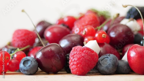 group of mixed fresh berries and cubes of coconut