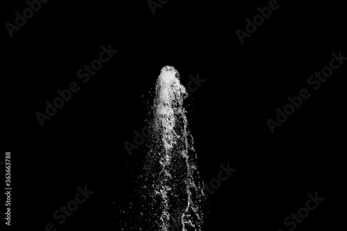 water jet rising up and splashing on a black background