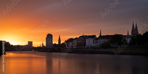 panorama of the river Weser in Bremen  Germany with city center and beautiful clouds at sunset