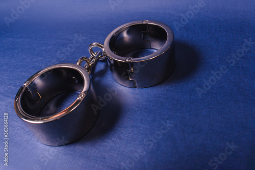 Tableau sur toile iron handcuffs Bdsm on a blue background