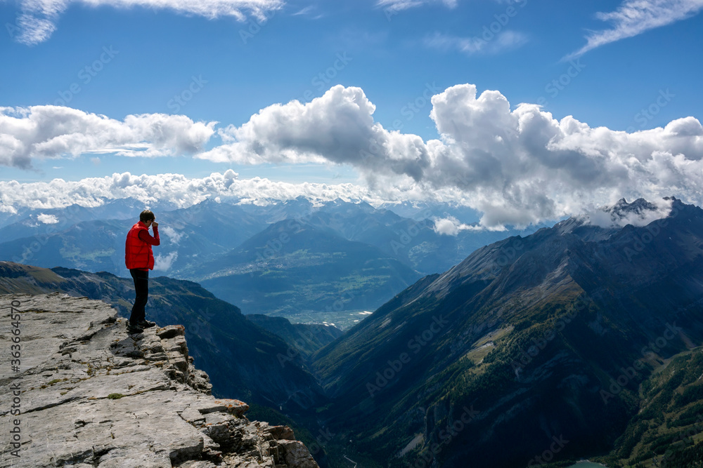 Guy looking down from a cliff